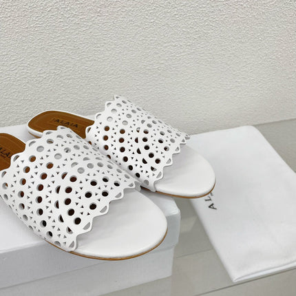 ALAIA VIENNE FLAT MULES IN WHITE LAMBSKIN