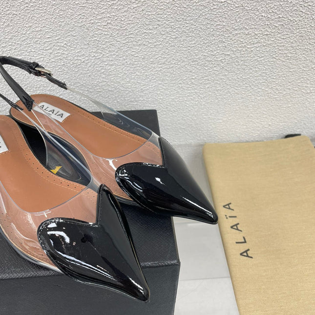 ALAIA LE COEUR FLAT SLINGBACKS IN BLACK PATENT LAMBSKIN