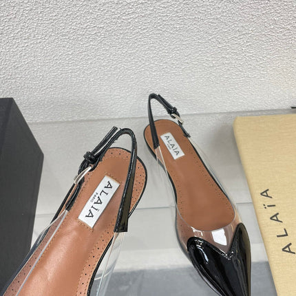 ALAIA LE COEUR FLAT SLINGBACKS IN BLACK PATENT LAMBSKIN