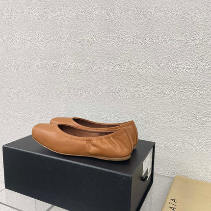 ALAIA BALLET FLATS IN COPPER BROWN CALFSKIN