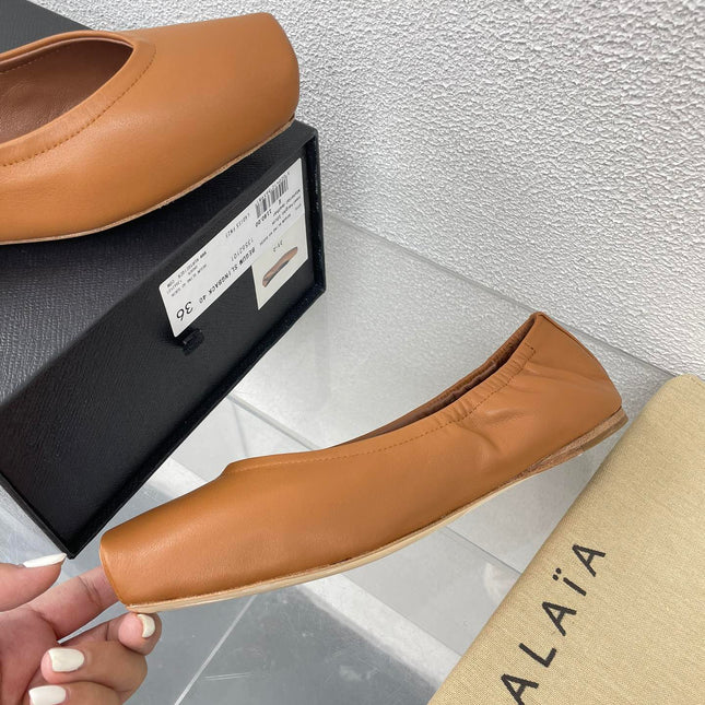 ALAIA BALLET FLATS IN COPPER BROWN CALFSKIN