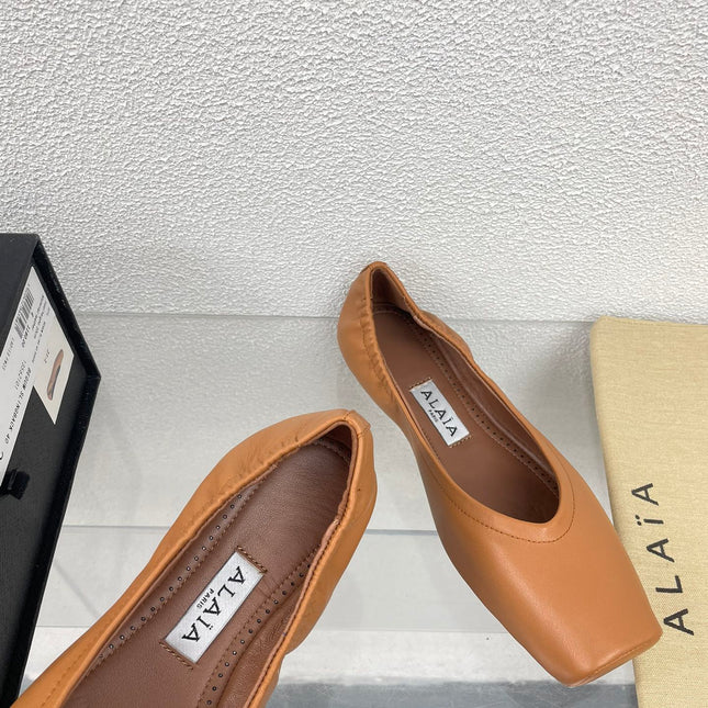 ALAIA BALLET FLATS IN COPPER BROWN CALFSKIN