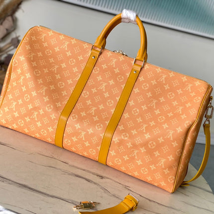 KEEPALL BANDOULIÈRE 55 IN ORANGE MONOGRAM HERITAGE CANVAS