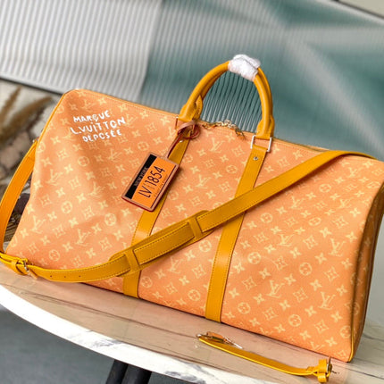KEEPALL BANDOULIÈRE 55 IN ORANGE MONOGRAM HERITAGE CANVAS