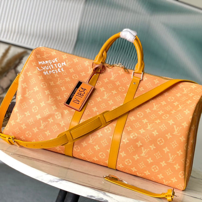 KEEPALL BANDOULIÈRE 55 IN ORANGE MONOGRAM HERITAGE CANVAS