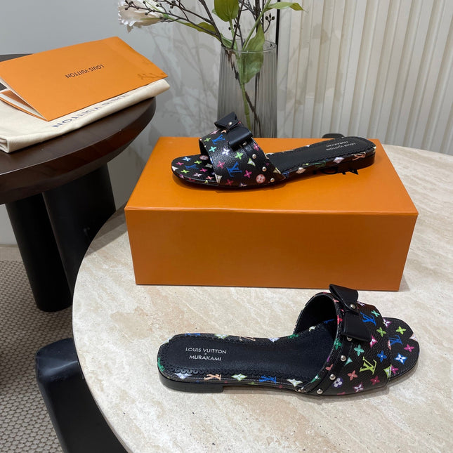 BOW FLAT MULES IN BLACK MONOGRAM LAMBSKIN