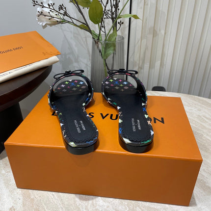 BOW FLAT MULES IN BLACK MONOGRAM LAMBSKIN