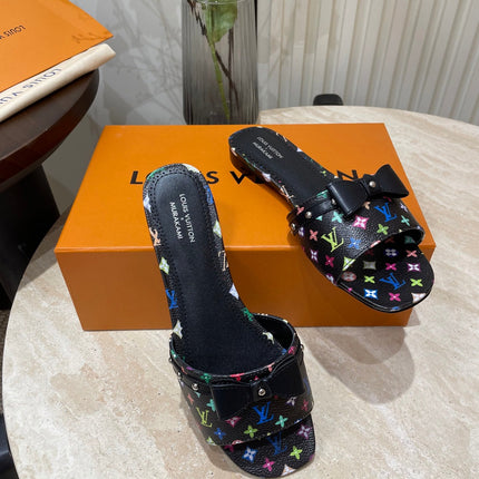 BOW FLAT MULES IN BLACK MONOGRAM LAMBSKIN