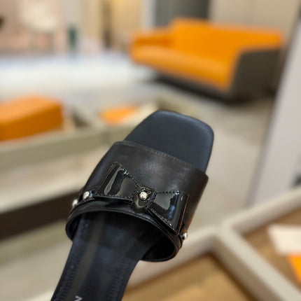 LV X TM 6AM FLAT MULE IN BLACK CALFSKIN