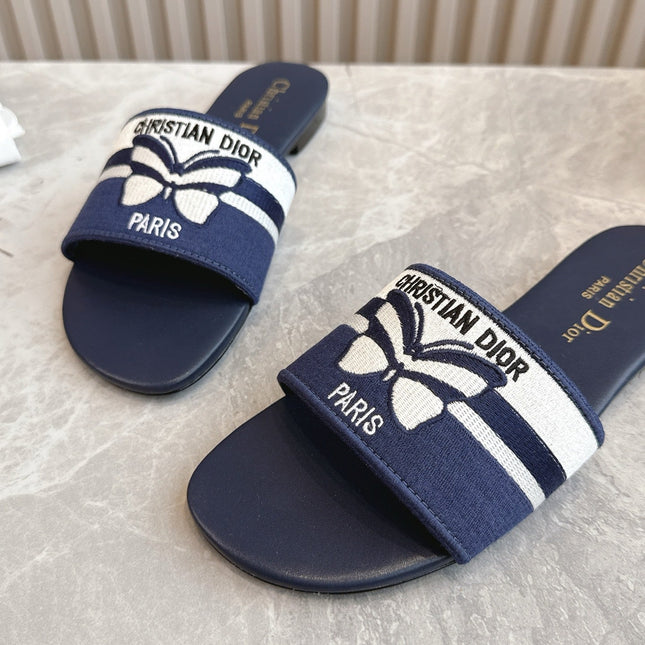 DIOR FLAT SLIDES 25S IN MIDNIGHT BLUE CALFSKIN AND FABRIC EMBROIDERED BUTTERFLY MOTIF