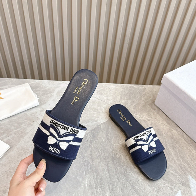 DIOR FLAT SLIDES 25S IN MIDNIGHT BLUE CALFSKIN AND FABRIC EMBROIDERED BUTTERFLY MOTIF