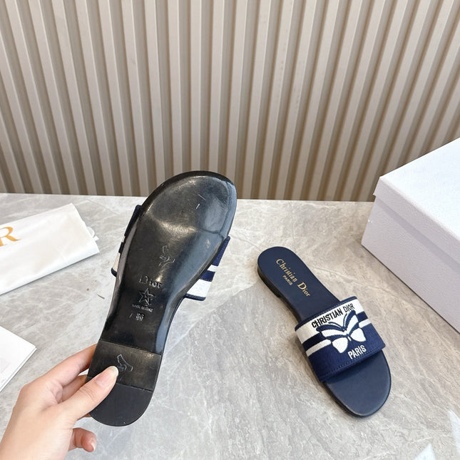DIOR FLAT SLIDES 25S IN MIDNIGHT BLUE CALFSKIN AND FABRIC EMBROIDERED BUTTERFLY MOTIF