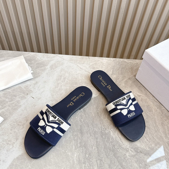 DIOR FLAT SLIDES 25S IN MIDNIGHT BLUE CALFSKIN AND FABRIC EMBROIDERED BUTTERFLY MOTIF