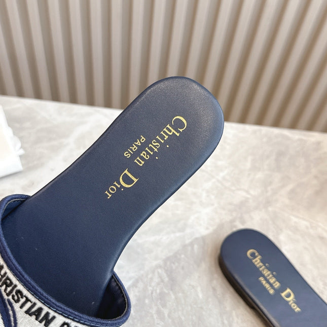DIOR FLAT SLIDES 25S IN MIDNIGHT BLUE CALFSKIN AND FABRIC EMBROIDERED BUTTERFLY MOTIF