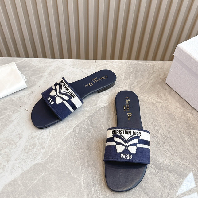 DIOR FLAT SLIDES 25S IN MIDNIGHT BLUE CALFSKIN AND FABRIC EMBROIDERED BUTTERFLY MOTIF