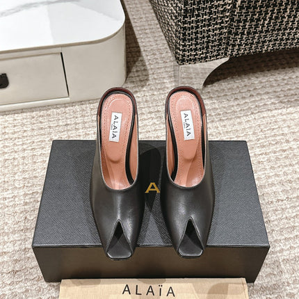 ALAIA SPIKE JEWEL MULES IN BLACK CALFSKIN