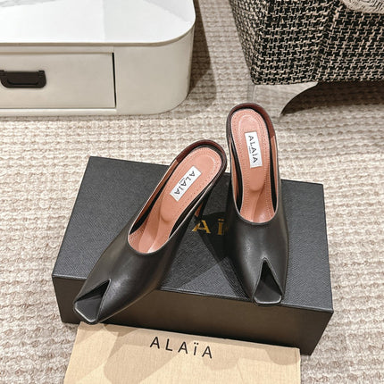 ALAIA SPIKE JEWEL MULES IN BLACK CALFSKIN