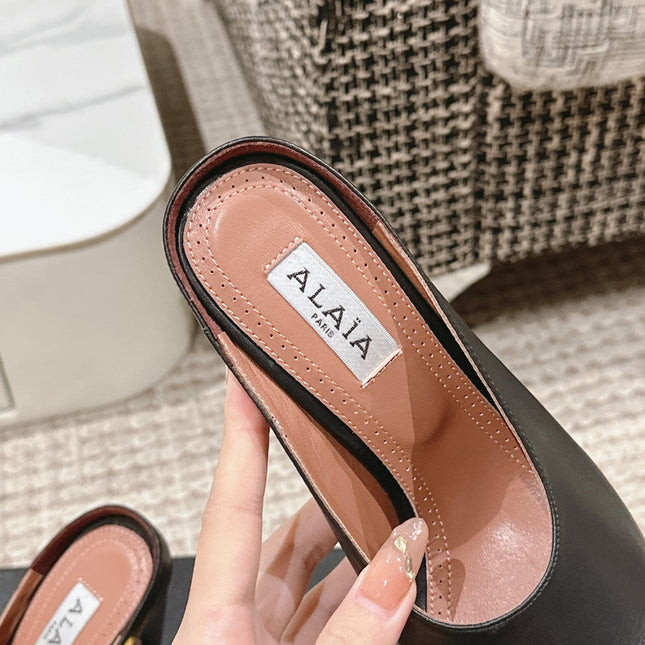 ALAIA SPIKE JEWEL MULES IN BLACK CALFSKIN