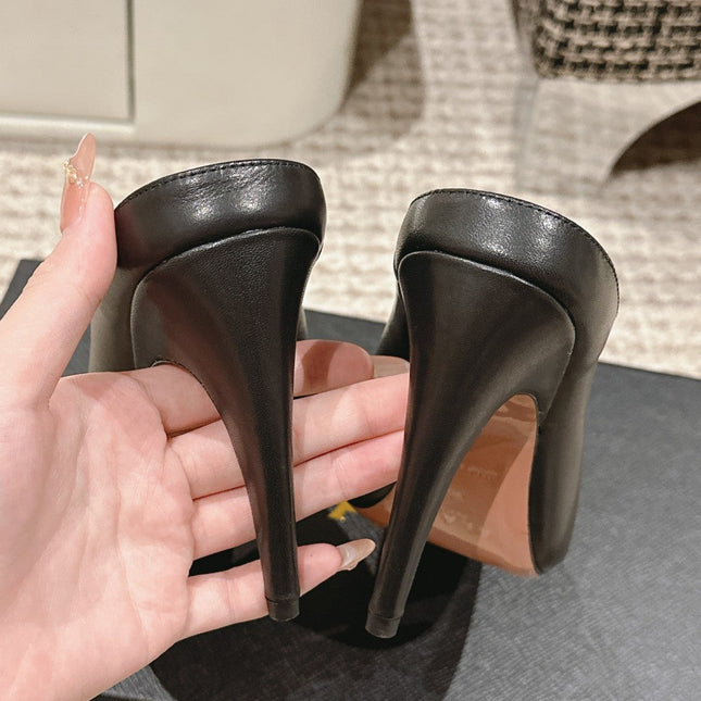 ALAIA SPIKE JEWEL MULES IN BLACK CALFSKIN