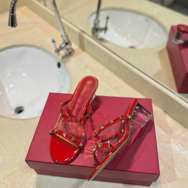 ROCKSTUD MULE SANDALS IN CHERRY RED CALFSKIN AND TRANSPARENT PVC FILM