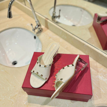 ROCKSTUD MULE SANDALS WITH TRANSPARENT HEEL IN WHITE CALFSKIN