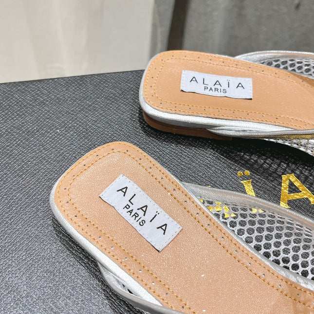 ALAIA FLAT MULES IN SILVER MESH FISHNET