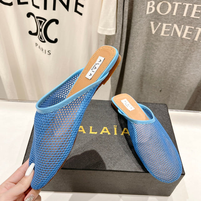 ALAIA FLAT MULES IN CERULEAN BLUE MESH FISHNET