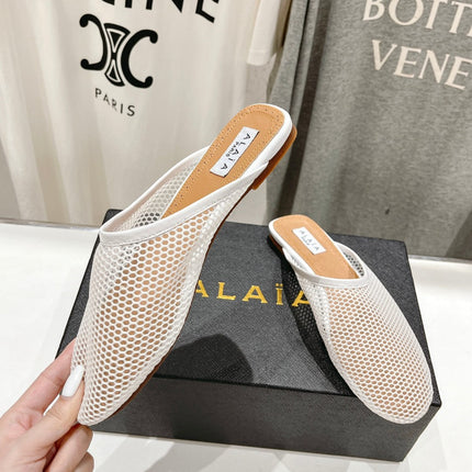 ALAIA FLAT MULES IN WHITE MESH FISHNET
