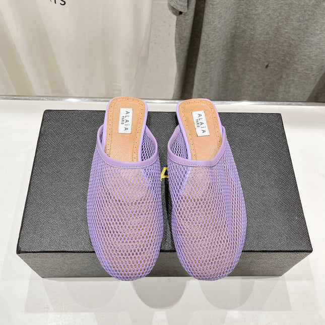 ALAIA FLAT MULES IN LIGHT PURPLE MESH FISHNET