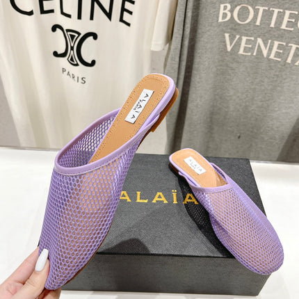 ALAIA FLAT MULES IN LIGHT PURPLE MESH FISHNET