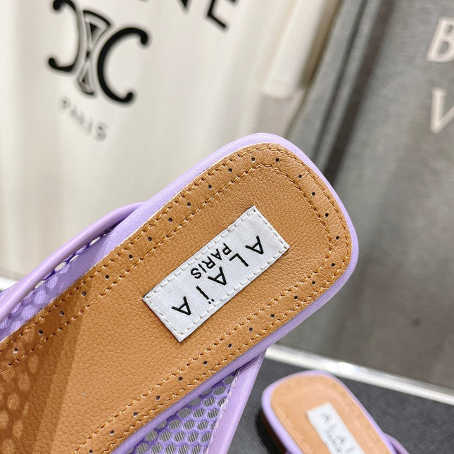 ALAIA FLAT MULES IN LIGHT PURPLE MESH FISHNET