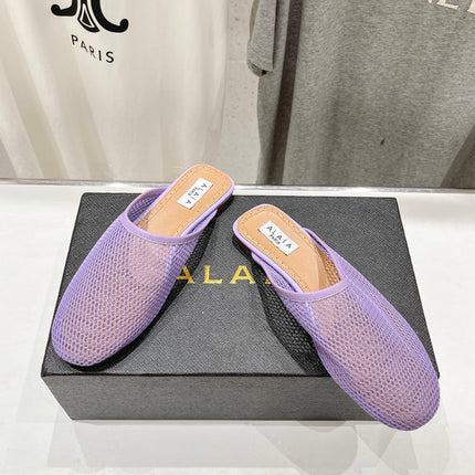 ALAIA FLAT MULES IN LIGHT PURPLE MESH FISHNET