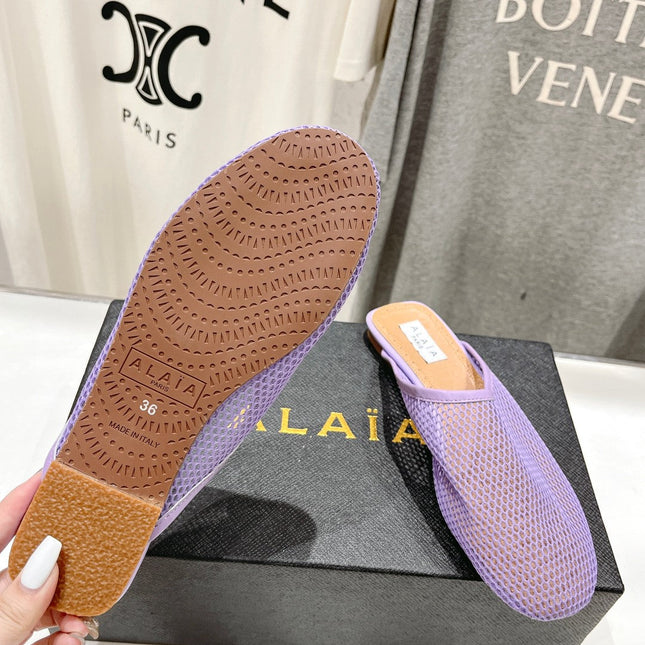 ALAIA FLAT MULES IN LIGHT PURPLE MESH FISHNET